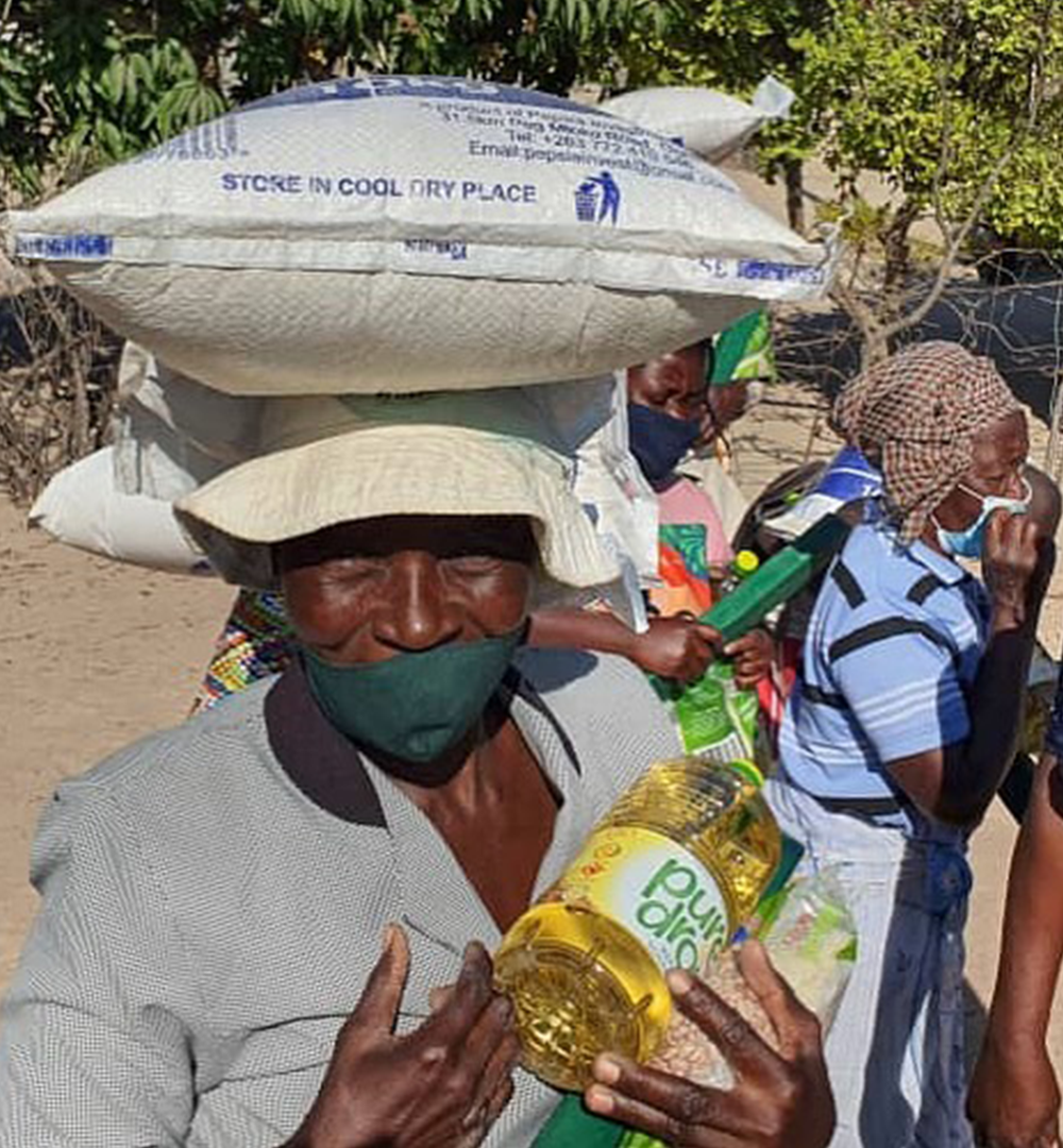 A woman carrying her food allocation home from a distribution